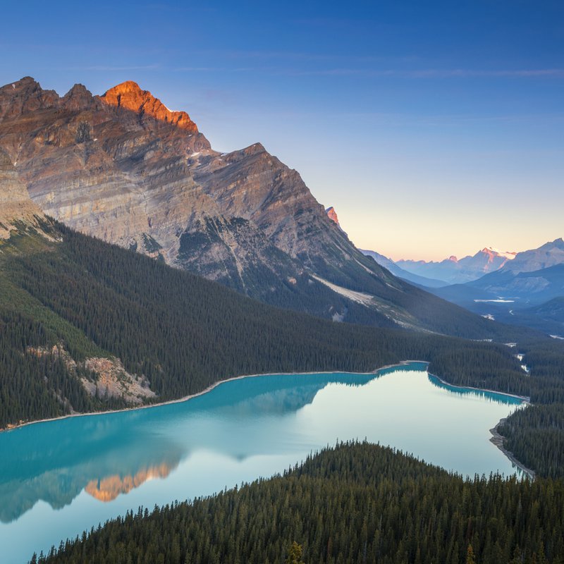 Lake at dawn with sun setting over mountains